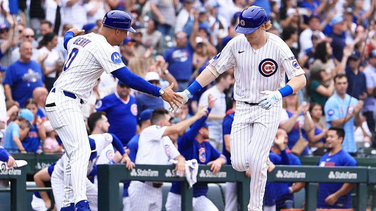 CHICAGO, ILLINOIS - AUGUST 19: Owen Caissie #19 of the Chicago Cubs celebrates his first career home run with coach Quintin Berry #0 of the Chicago Cubs during the sixth inning against the Milwaukee Brewers in game one of a double header at Wrigley Field on August 19, 2025 in Chicago, Illinois. (Photo by Geoff Stellfox/Getty Images)