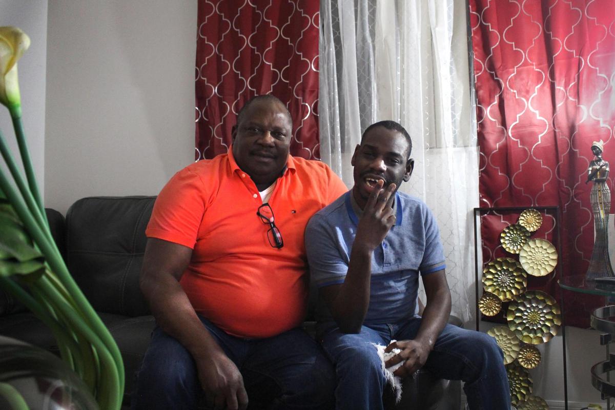 Clarens Philippe, right, and his father, Ronald Philippe, in their home in Opa-locka.