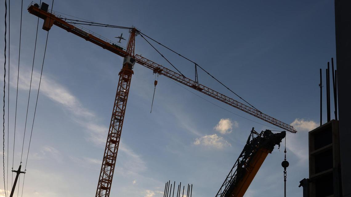 On Thursday, March 2, 2023, a jet flies over the crane at the Wynwood Plaza construction site. The $215 million development will include apartments, offices, stores and restaurant space.