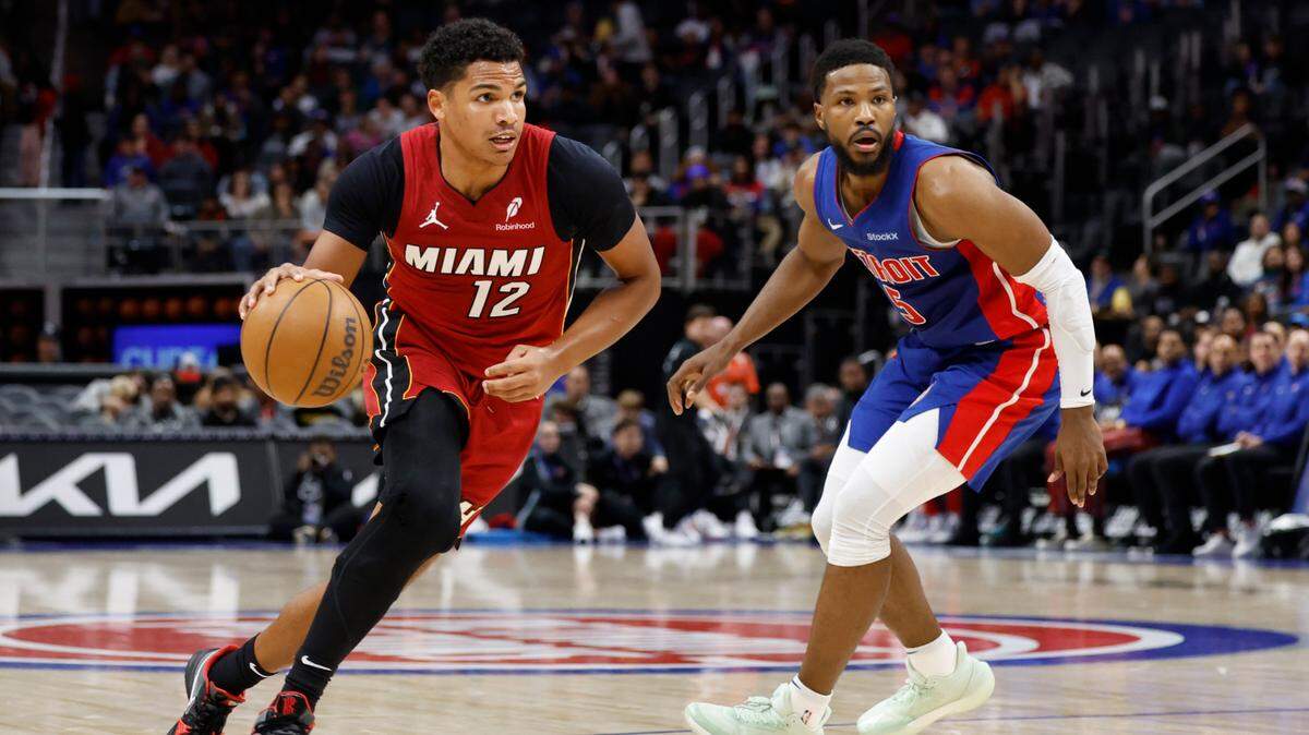 Miami Heat guard Dru Smith (12) dribbles past Detroit Pistons guard Malik Beasley (5) in the first half at Little Caesars Arena.