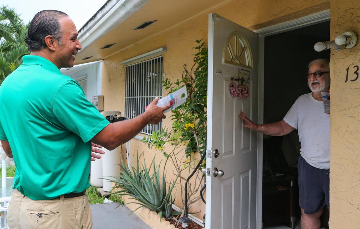 Elvis Maldonado, a mayoral candidate for the City of Homestead, speaks with city resident Fernando Naya on Thursday, Sept. 3, 2021.