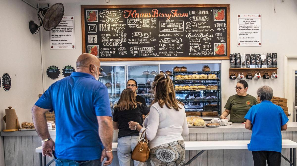 Customers line up for cinnamon rolls, bread, jams and pies and other homemade goodies at Knaus Berry Farm in Homestead.