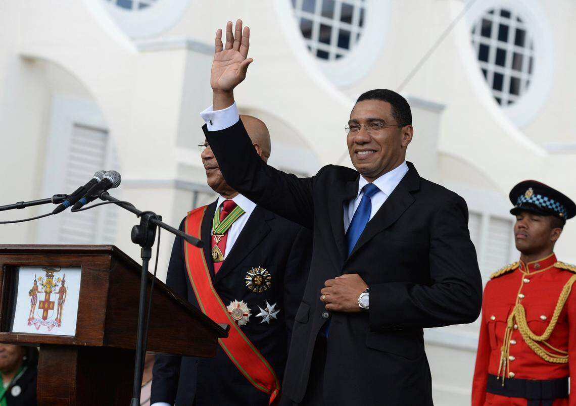 In this March 3, 2016 file photo, Jamaican Prime Minister Andrew Holness waves to the crowd after being sworn into office, in Kingston, Jamaica. Holness led his Jamaica Labor Party to “a tsunami-like” victory Thursday in the country’s general elections amid a soaring coronavirus pandemic, according to preliminary results.