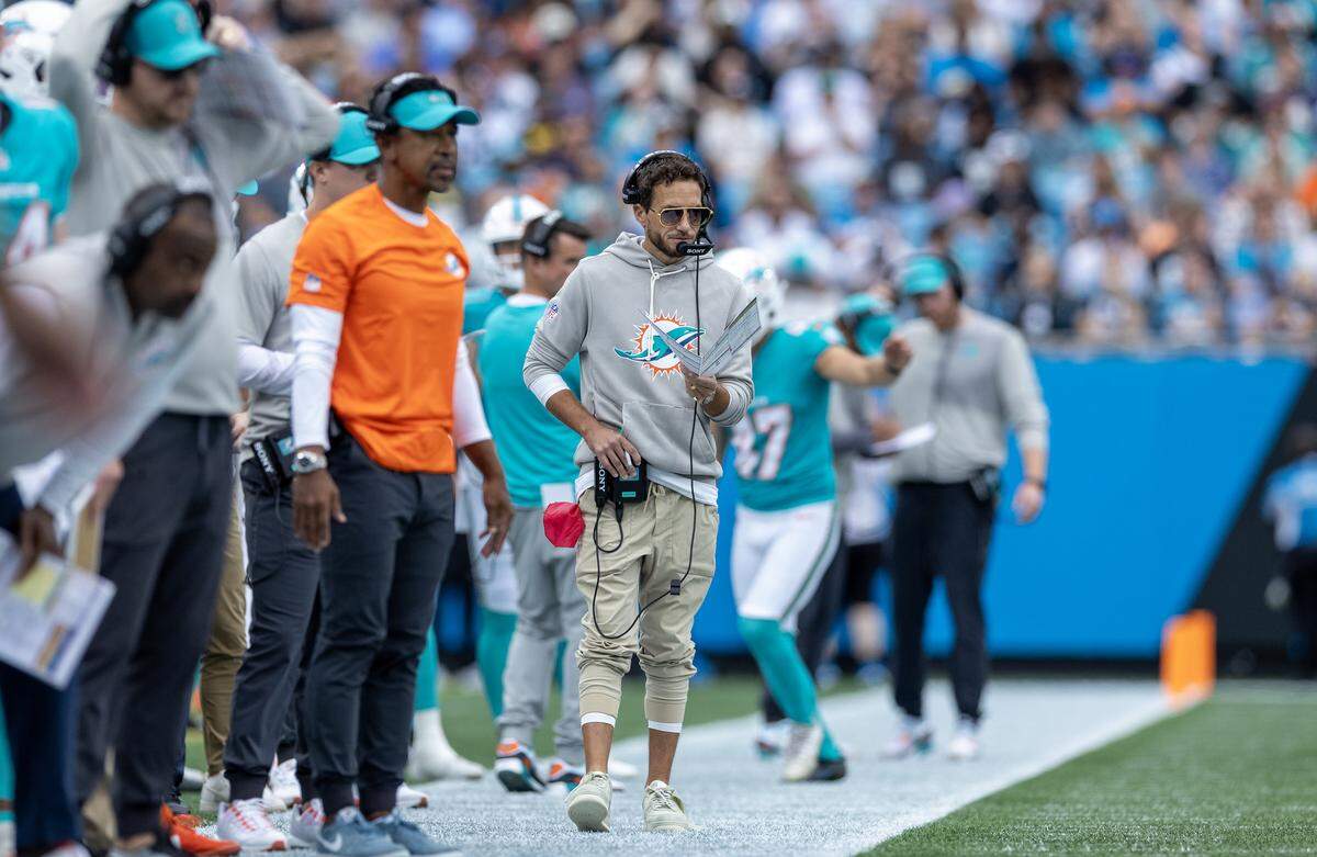 Miami Dolphins head coach Mike McDaniel watches from the sideline during the first half of an NFL football game against the Carolina Panthers, Sunday, Oct. 5, 2025, in Charlotte, N.C.