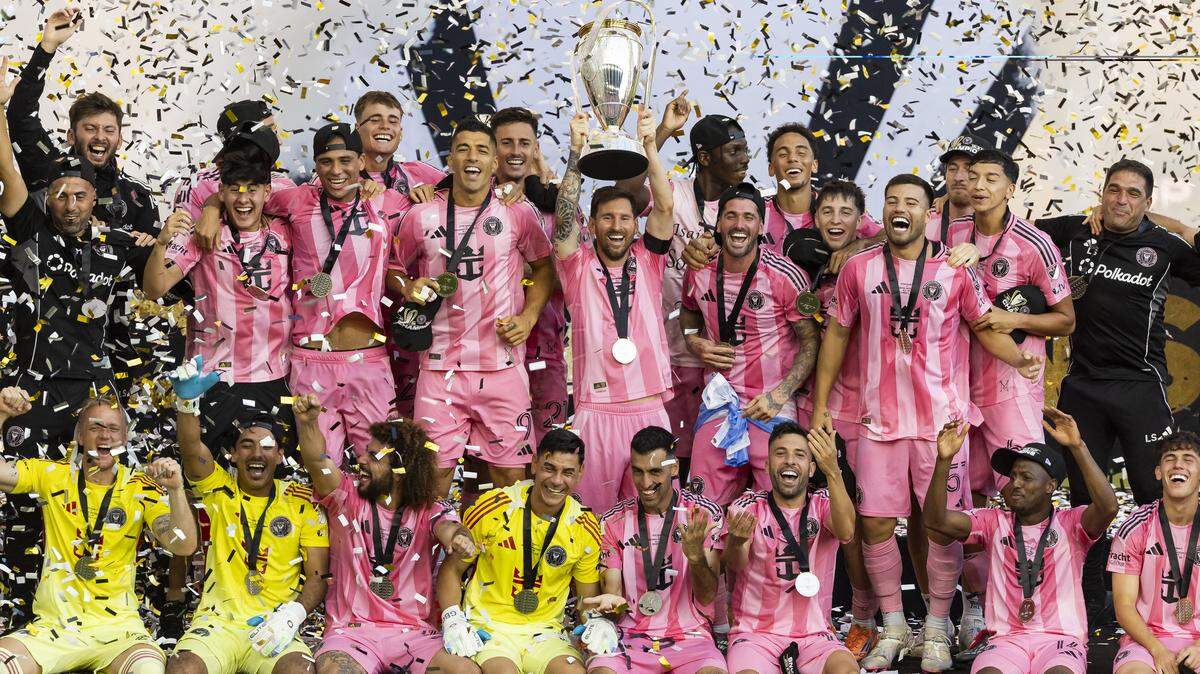 Inter Miami forward Lionel Messi (10) lifts the Philip F. Anschutz Trophy alongside his teammates after they defeated Vancouver Whitecaps in their MLS Cup final match at Chase Stadium on Saturday, Dec. 6, 2025, in Fort Lauderdale, Fla.