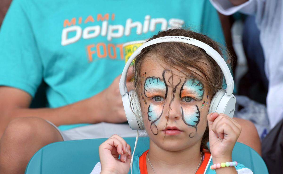 Miami Dolphins fan Finley Barnell, 5, waits for the start of practice at Baptist Health Training Complex in Miami Gardens on Saturday, July 30, 2022.