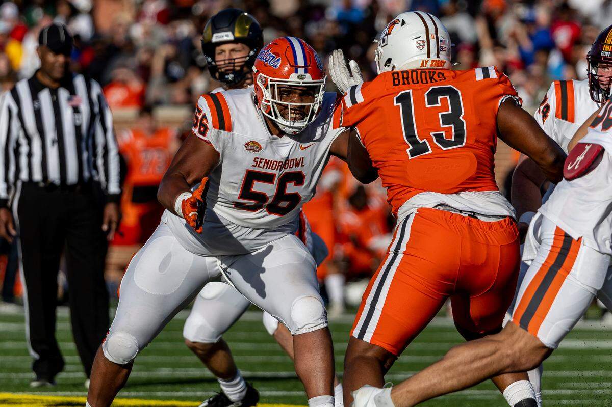Feb 4, 2023; Mobile, AL, USA; American offensive lineman O’Cyrus Torrence of Florida (56) looks to block National defensive lineman Karl Brooks of Bowling Green (13) during the second half of the Senior Bowl college football game at Hancock Whitney Stadium. Mandatory Credit: Vasha Hunt-USA TODAY Sports