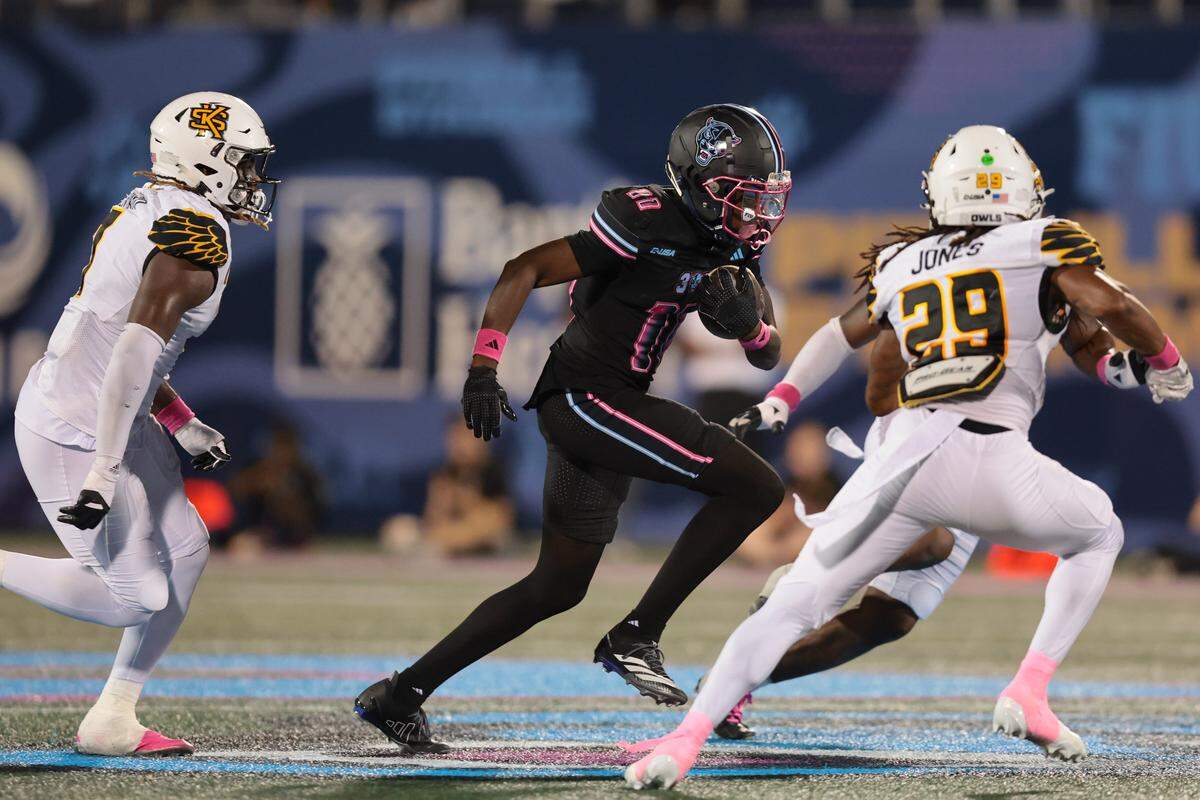 FIU Panthers wide receiver Eric Nelson (11) carries the football against Kennesaw State Owls defensive back Milon Jones (29) during the second quarter at Pitbull Stadium in Miami, Florida, Tuesday, October 21, 2025.