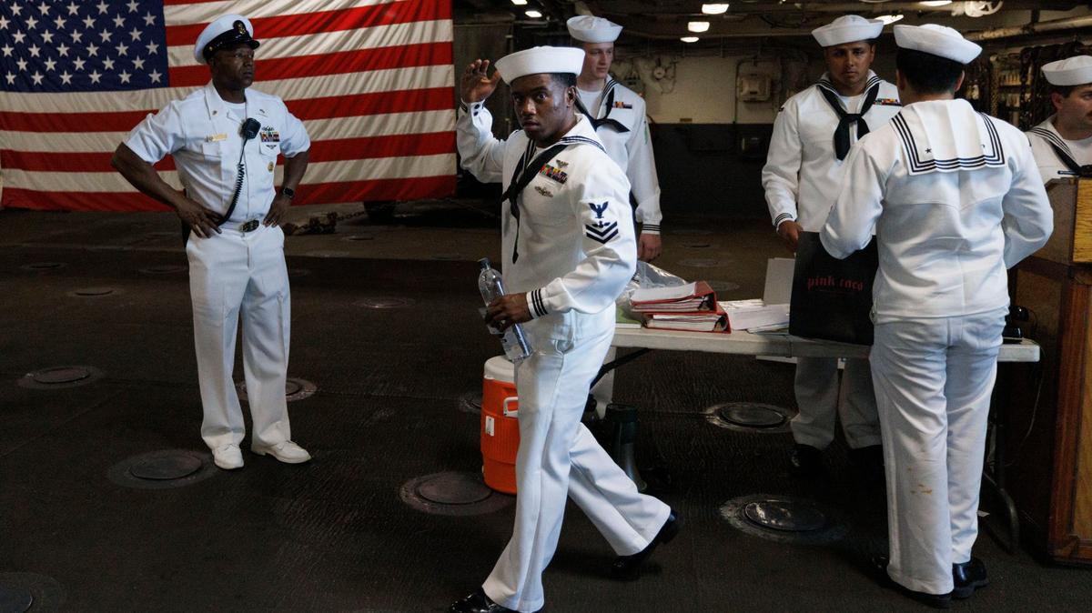 Sailors salute as they board the USS Bataan during the opening day of Fleet Week on Monday, May 6, 2024, at Norwegian Cruise Lines Terminal in PortMiami.