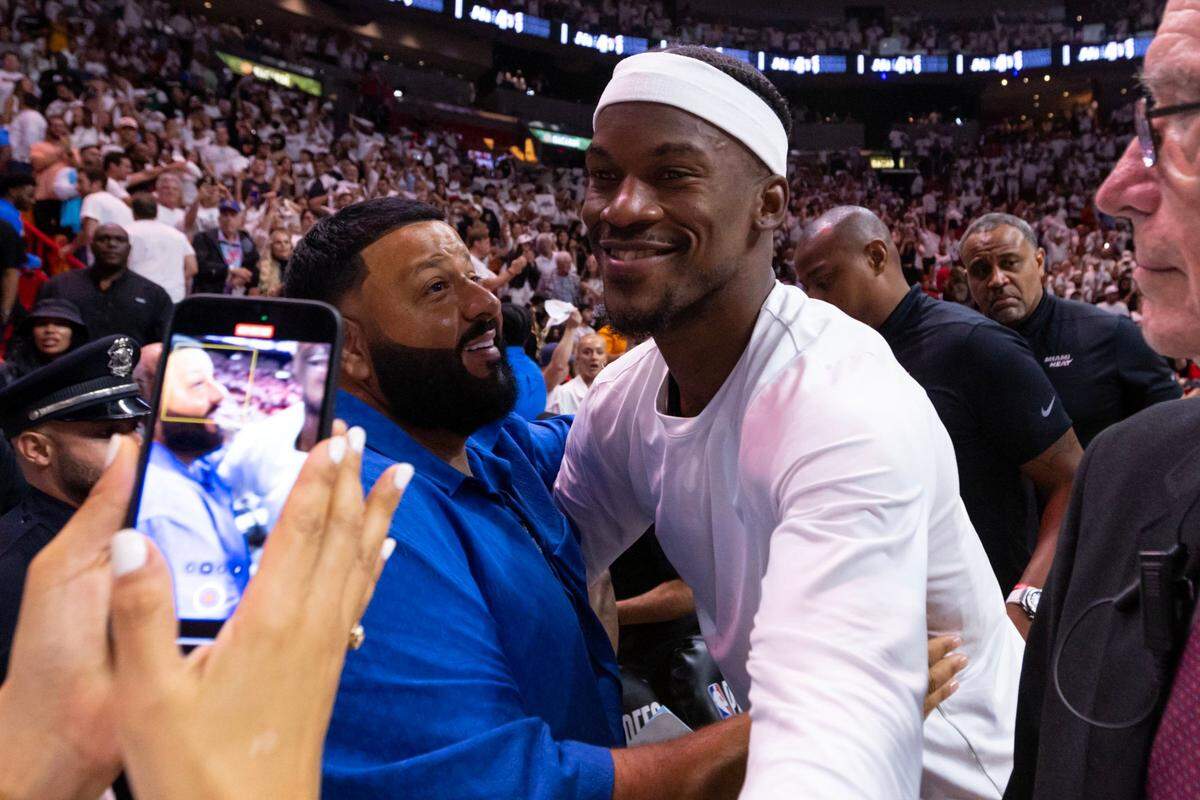 Miami Heat forward Jimmy Butler reacts with DJ Khaled after his team defeated the Boston Celtics 128-102 after the fourth quarter of Game 3 of the NBA Eastern Conference Finals series at Kaseya Center in Miami, Florida, on May 21, 2023.