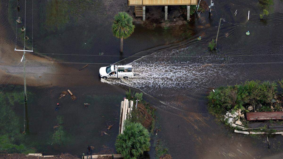 A truck treads the water in Suwannee, Fla., as seen from the air Friday, Sept. 27, 2024, following Hurricane Helene’s landfall as a category 4 storm Thursday night. (Diego Perdomo/WUFT News)