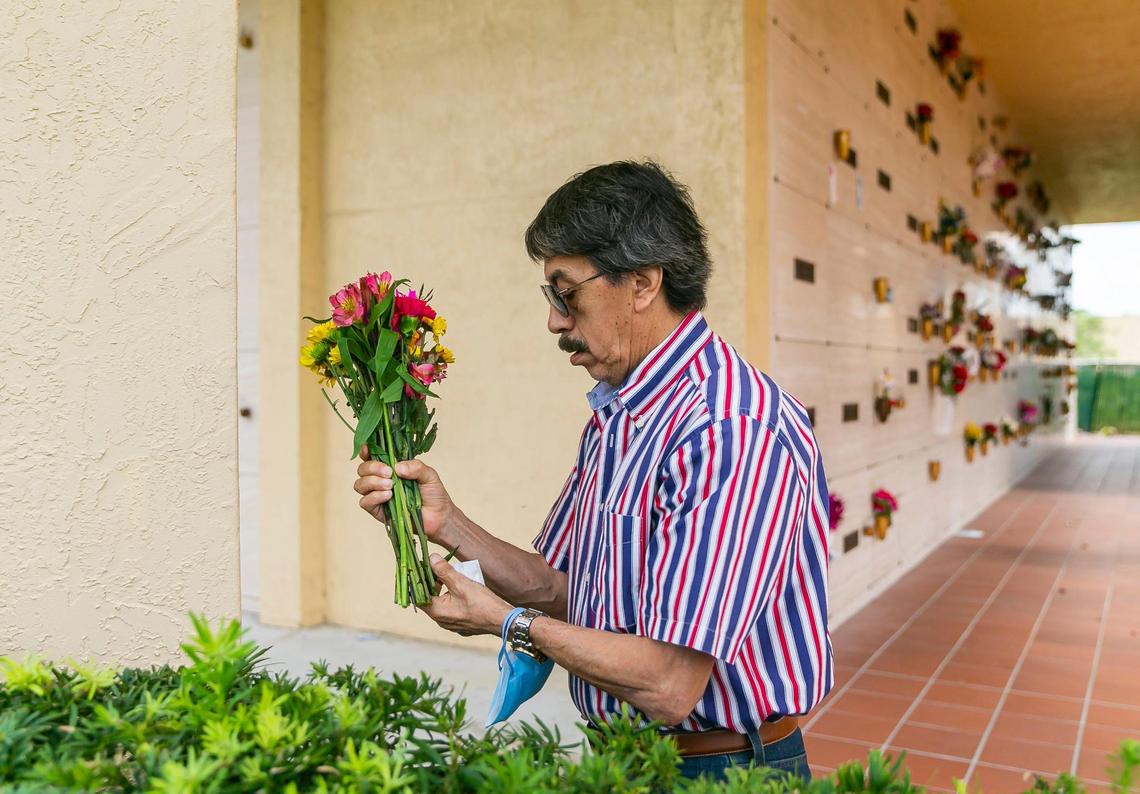 Orlando Duran, the father of Alexa Duran, prepares to place flowers at his daughter’s resting place in Vista Memorial Gardens in Miami Lakes, Florida on Sunday, March 13, 2022. Alexa Duran is one of six victims who were killed outside of Florida International University when a pedestrian bridge, still underway, collapsed on March 15, 2018.