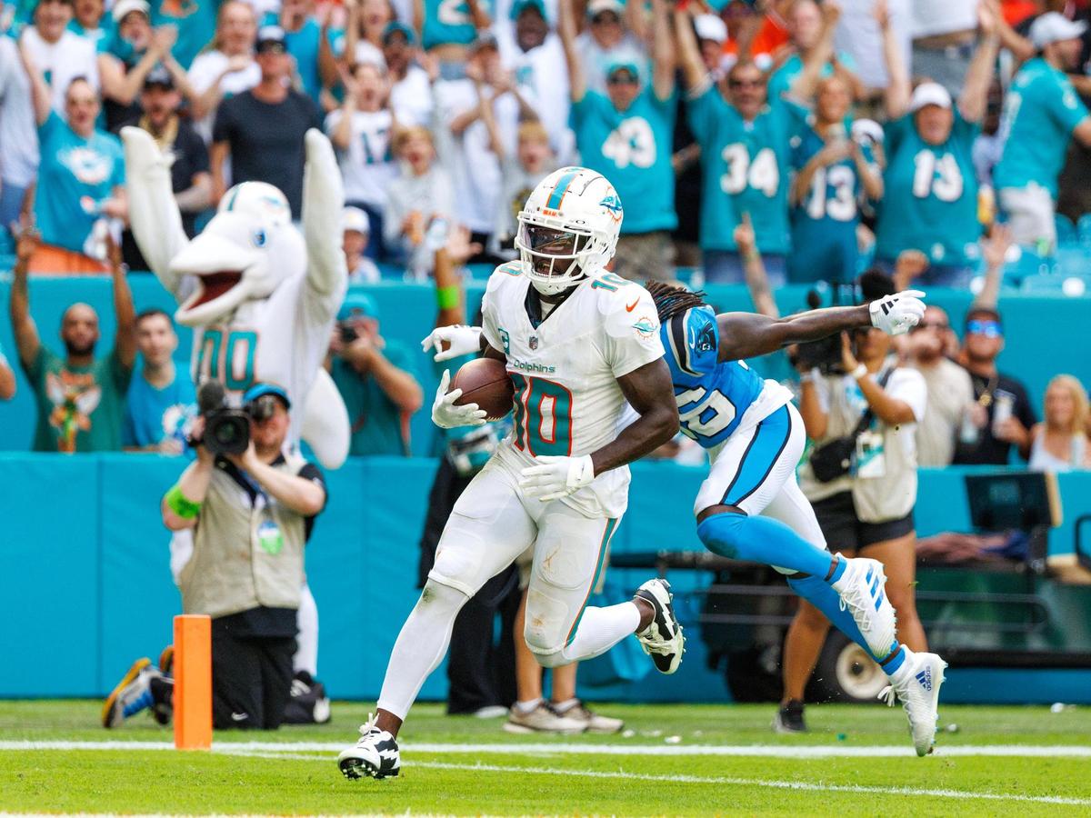 Miami Dolphins wide receiver Tyreek Hill (10) scores a touchdown as Carolina Panthers cornerback Donte Jackson (26) defends during second quarter of an NFL football game at Hard Rock Stadium on Sunday, Oct. 15, 2023 in Miami Gardens, Fl.