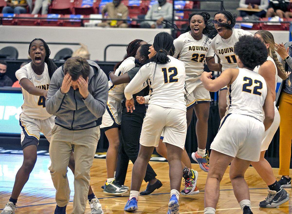 St Thomas Aquinas Oliver Berens puts his face in hands as the team celebrates after defeating Wekiva in the FHSAA Girls Basketball 6A Finals in Lakeland, Florida, Saturday, February 27, 2021.