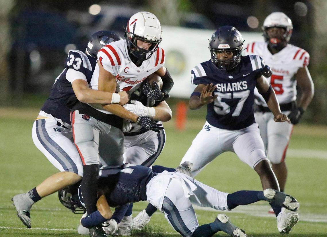 Westminster Academy Lions wide receiver Evan Tempro (1) is tackled by University School Sharks defenders during the football game on Thursday, October 12, 2023 in Davie. Andrew Uloza / for Miami Herald