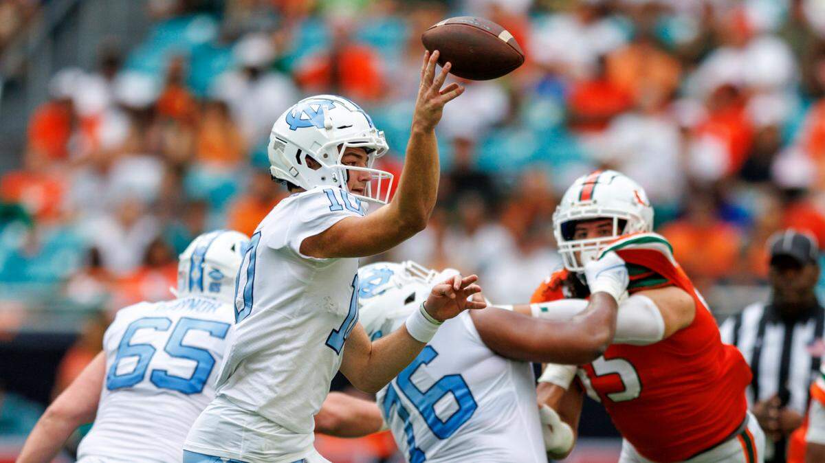 North Carolina Tar Heels quarterback Drake Maye (10) sthrows a pass during the first quarter of an ACC conference football game against the Miami Hurricanes at Hard Rock Stadium on Saturday, October 8, 2022 in Miami Gardens, Florida..