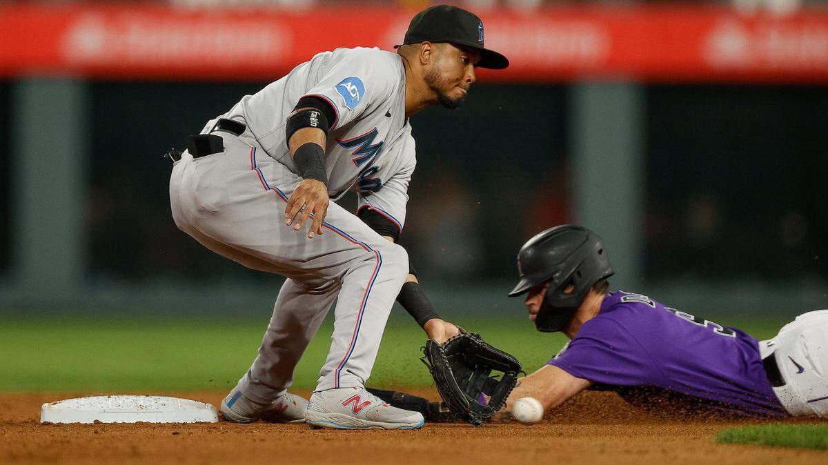May 22, 2023; Denver, Colorado, USA; Colorado Rockies center fielder Brenton Doyle (9) safely steals second ahead of the throw to Miami Marlins second baseman Luis Arraez (3) in the seventh inning at Coors Field. Mandatory Credit: Isaiah J. Downing-USA TODAY Sports