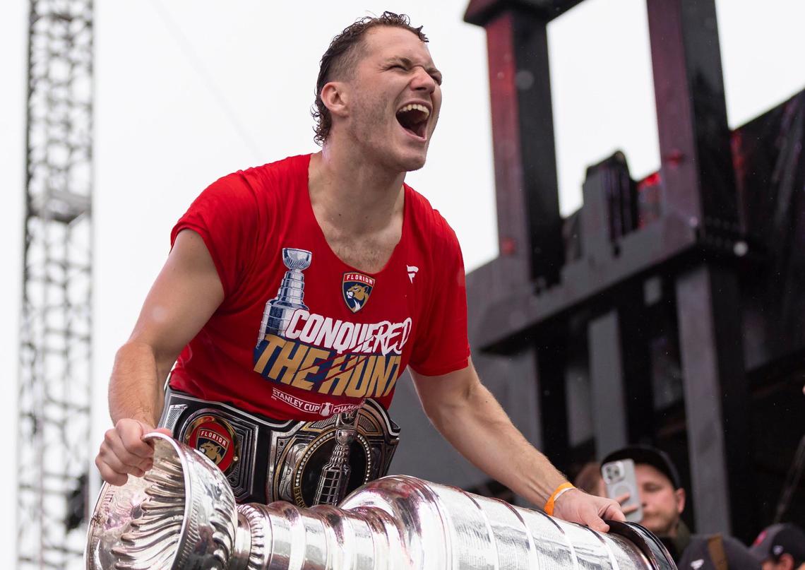Florida Panthers left wing Matthew Tkachuk (19) reacts while holding the Stanley Cup during a victory parade rally at the Fort Lauderdale Beach Park off A1A on Sunday, June 30, 2024, in Fort Lauderdale, Fla. The parade was held to celebrate the Florida Panthers after they defeated the Edmonton Oilers in Game 7 of the Stanley Cup Final.