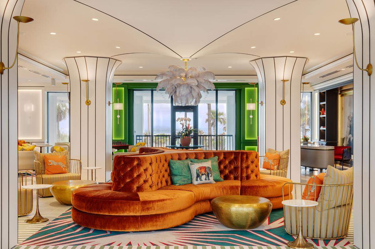 Green lion topiaries, velvet couches, feather chandeliers and striped columns set the stage for a stay that’s equal parts glam and whimsical.
