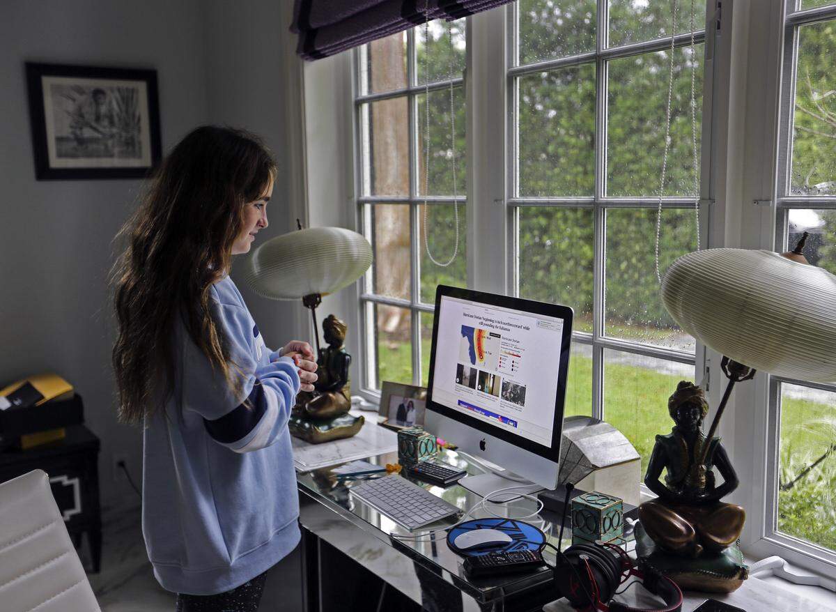 Claire Luce, 12, is constantly checking the latest developments regarding Hurricane Dorian on the family computer as she and her family wait for the latest news on the storm’s path as it moved slowly on a northern track about 100 miles off of Palm Beach, Florida on Tuesday, September 3, 2019.