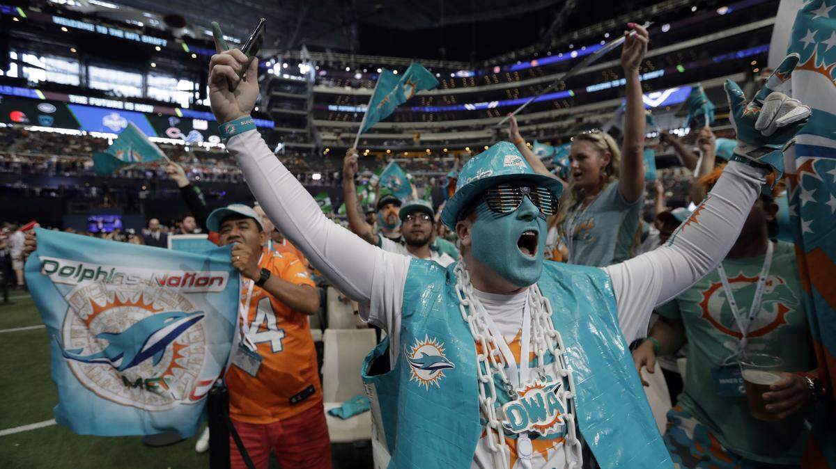 Miami Dolphins fans cheer during the second round of the draft Friday night.