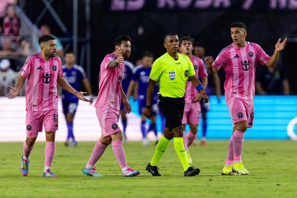 Inter Miami forward Lionel Messi (10), forward Luis Suárez (9) and defender Jordi Alba (18) speaks to a referee during the first half of an MLS match against the Orlando City at Chase Stadium on Sunday, May 18, 2025, in Fort Lauderdale, Fla.