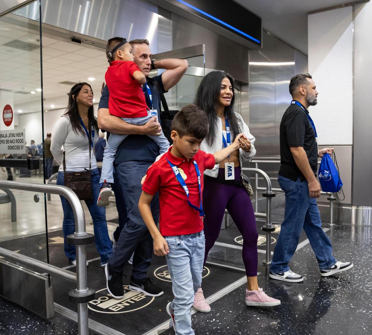 From left to right: Parker Hansen, 5, Paul Hansen, Cooper Hansen, 7, and Carol Hansen participate in the MIAair tour at the Miami International Airport on Monday, Oct. 23, 2023, in Miami, Fla. The MIA Airport Instruction and Readiness tour allows more than 30 children with special needs to walk through an airport travel experience from start to finish in a safe and controlled environment.