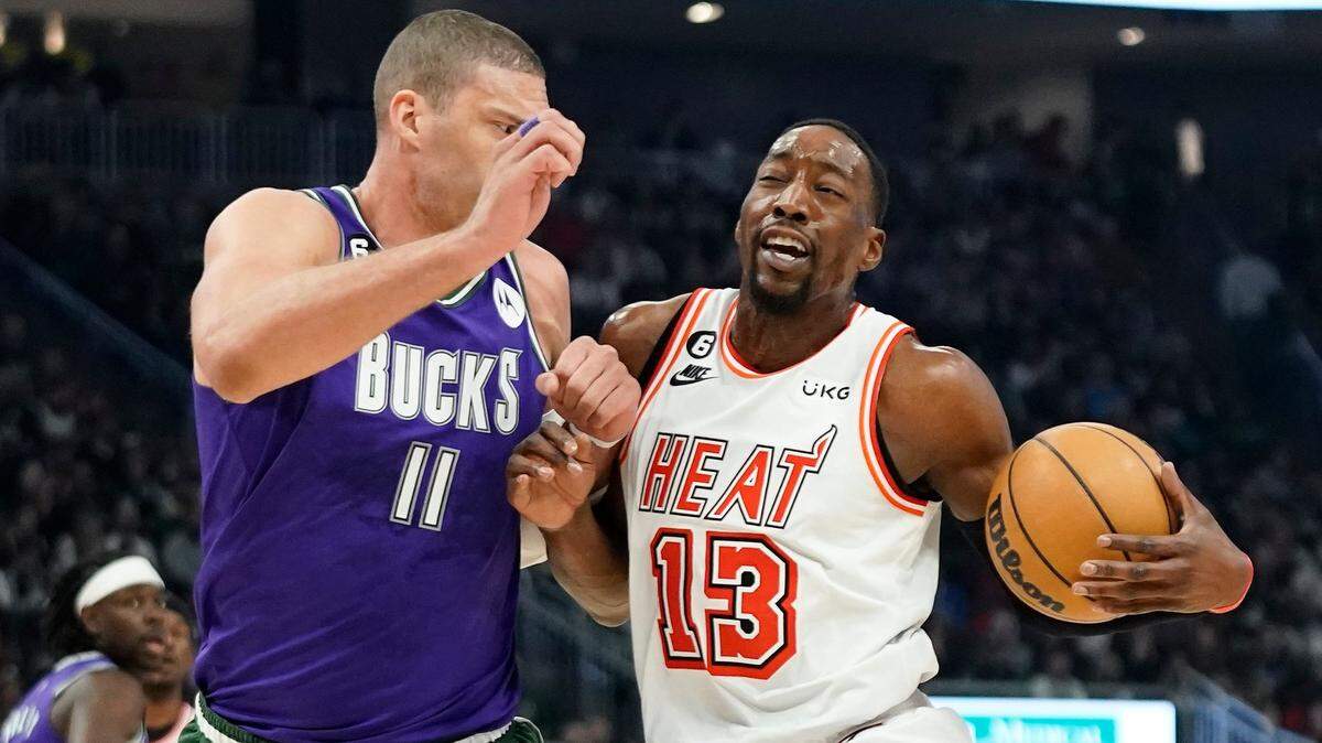 Miami Heat’s Bam Adebayo, right, drives to the basket against Milwaukee Bucks’ Brook Lopez during the first half of an NBA basketball game Friday, Feb. 24, 2023, in Milwaukee.