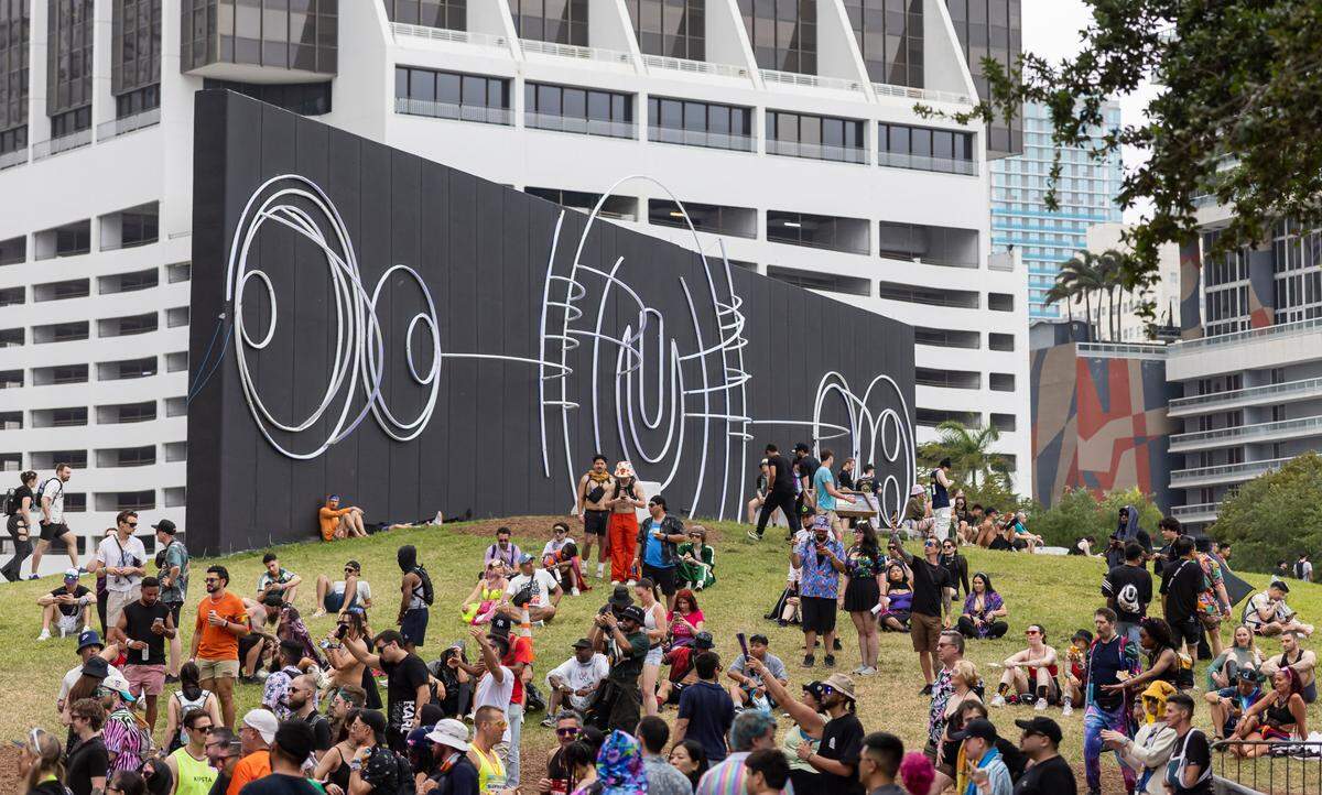 People gather on a hill for some rest during Ultra Music Festival’s 25th anniversary at Bayfront Park on Saturday, March 29, 2025, in downtown Miami, Fla. 