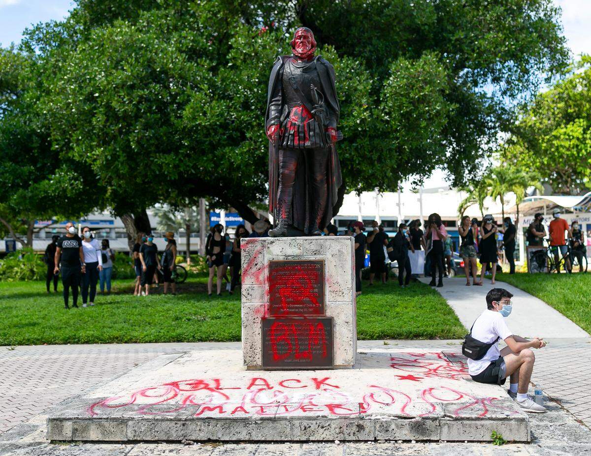 People gather in downtown Miami before the start of an anti-racism protest on Saturday, June 13, 2020, near the Torch of Friendship and the Juan Ponce de Leon statue that was vandalized during a Black Lives Matter protest on Wednesday June 10.