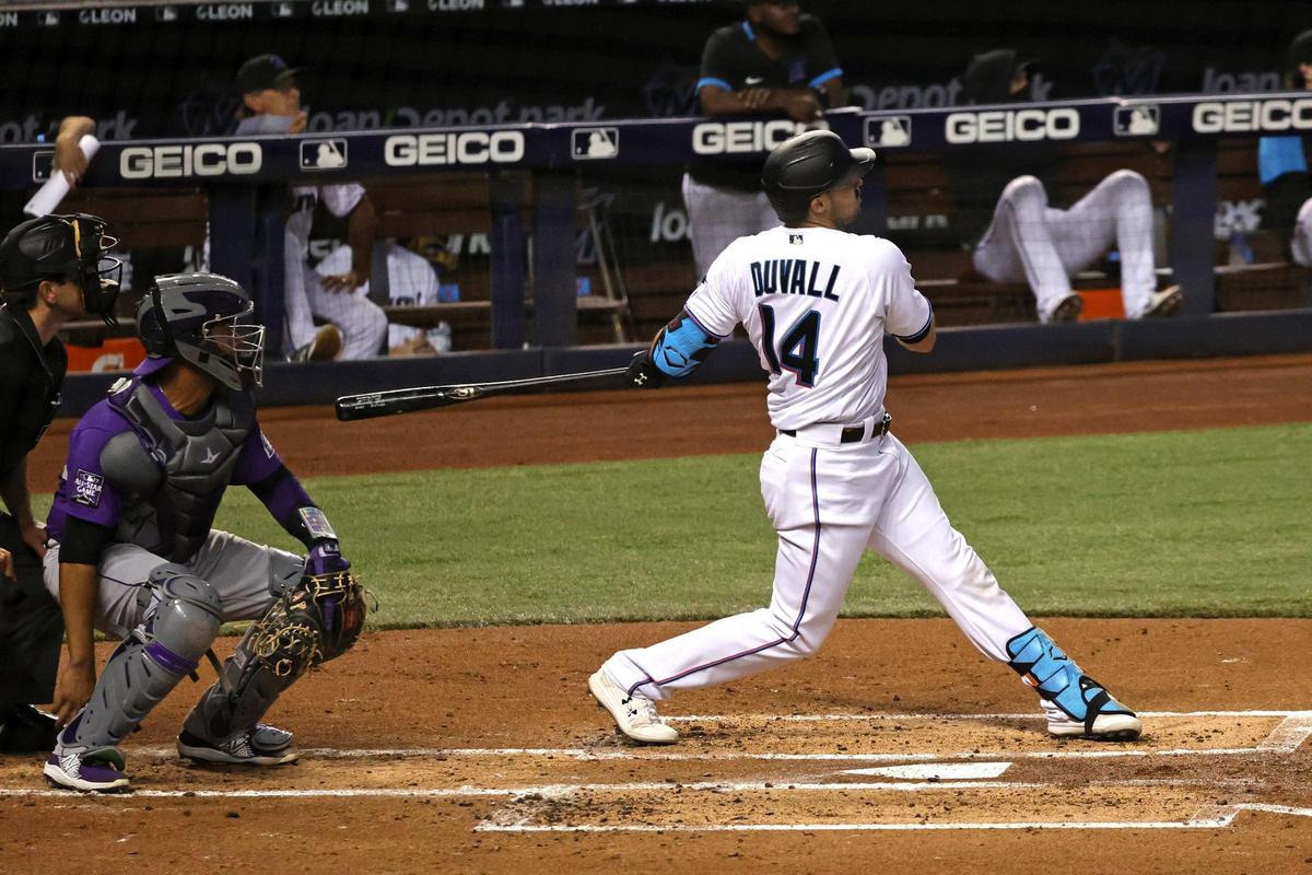 Miami Marlins right fielder Adam Duvall (14) hits a two run home run during the second inning of their baseball game against the Colorado Rockies at loanDepot park on Thursday, June 10, 2021 in Miami, Florida.