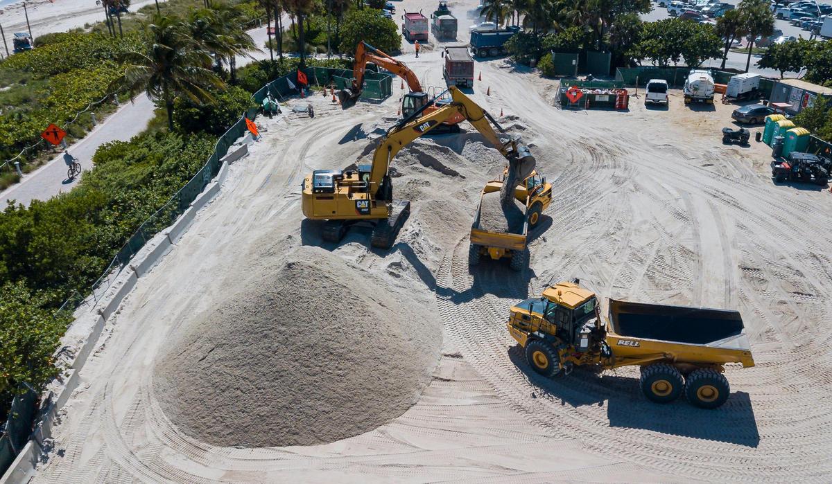 A truck is loaded with sand near Indian Beach Park on Wednesday, Oct. 12, 2022, in Miami Beach, Fla.