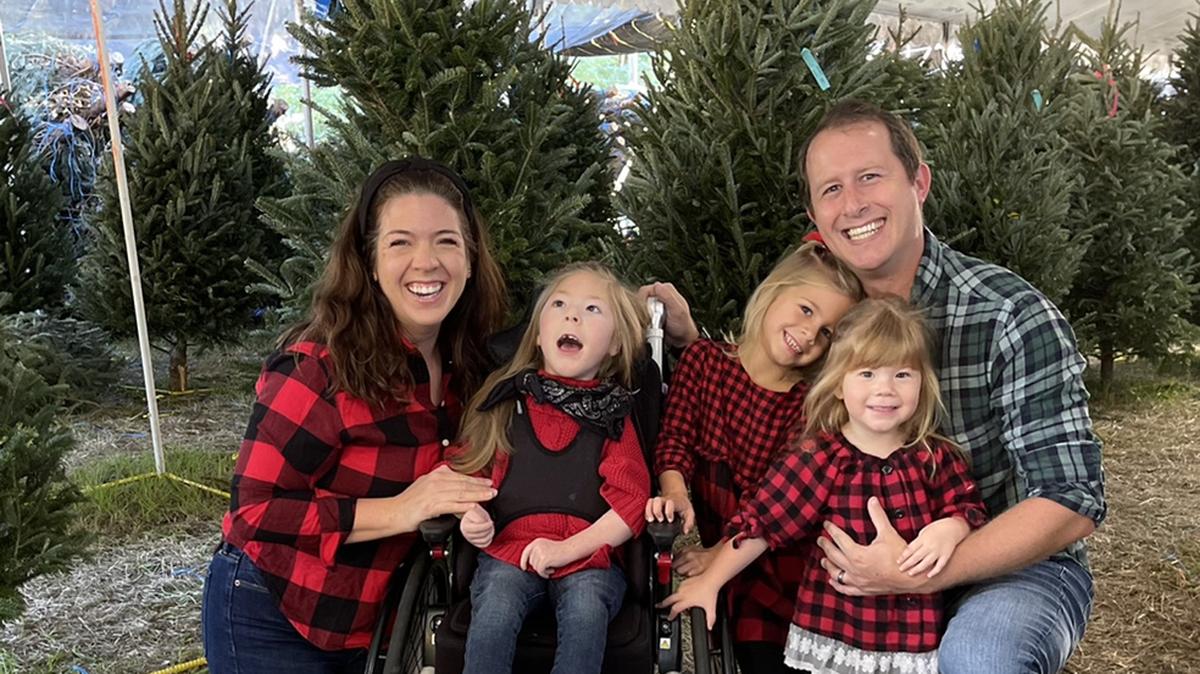 Dan and Jennifer Bookhout with their family, including their daughter Arwen at the center.