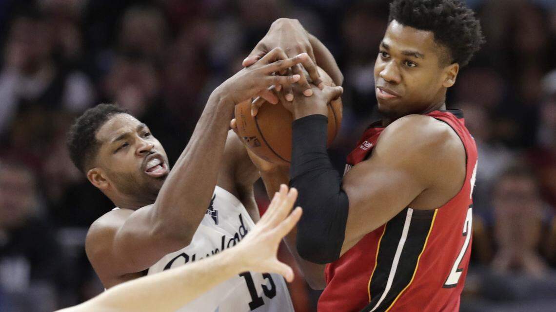 Cleveland Cavaliers’ Tristan Thompson, left, and Miami Heat’s Hassan Whiteside battle for the ball in the first half of an NBA basketball game, Wednesday, Jan. 2, 2019, in Cleveland. (AP Photo/Tony Dejak)
