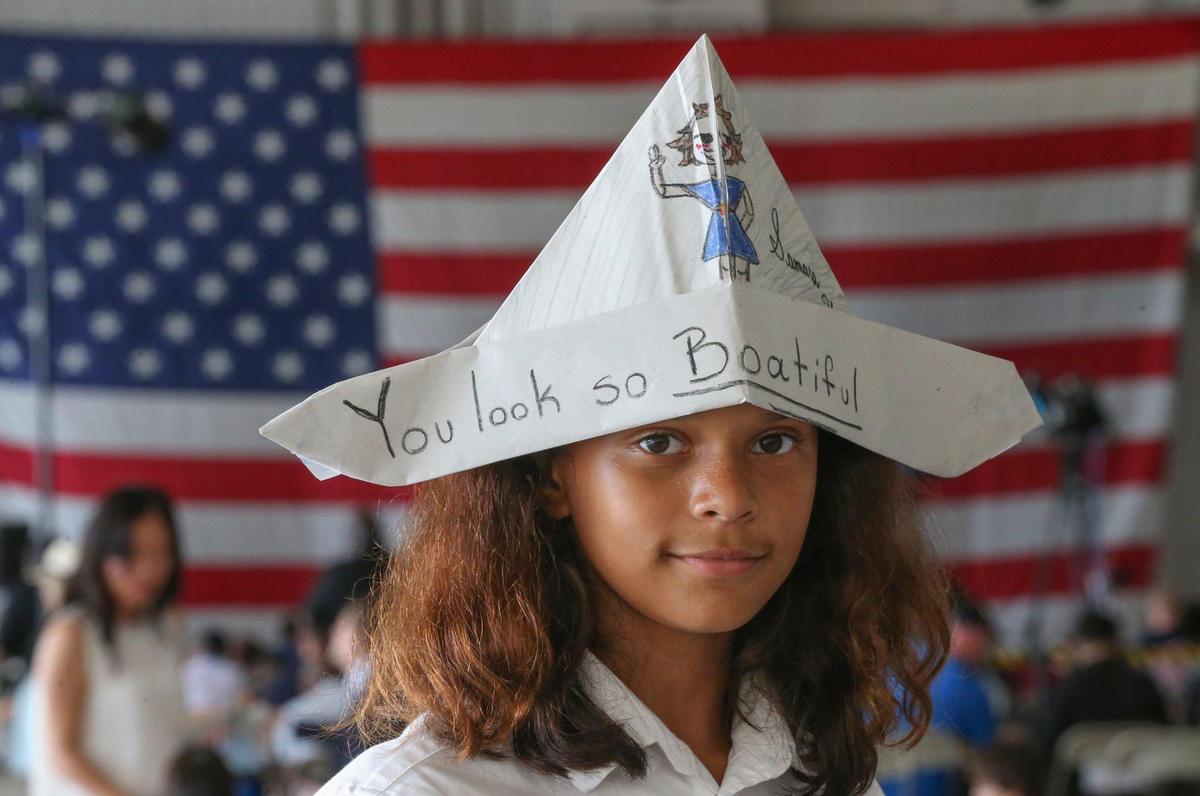 Samara Hutchinson, 10, of Miami waits for the arrival of first lady Jill Biden at U.S. Coast Guard Air Station Miami in Opa-locka for a private listening session with military families on Friday, Feb. 18, 2022.