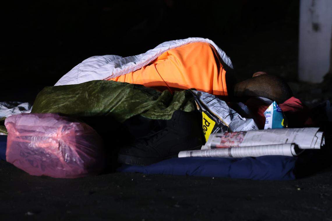 A man experiencing homelessness sleeps under the Interstate 95 overpass during the Homeless Trust's biannual Homeless Census in downtown Miami on Thursday, Jan. 22, 2026.
