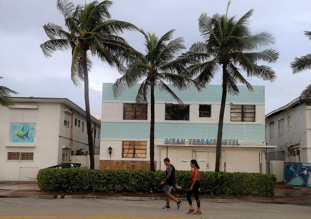 A couple walk on Ocean Terrace and 73rd Street in Miami Beach as Hurricane Isaias is forecast to arrive near the FL Atlantic coast tonight as a Category 1 hurricane, on Saturday August 01, 2020