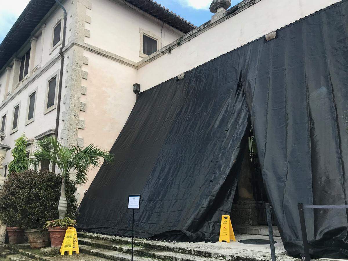 An armor screen is placed over the front of a glassed-in loggia at Miami’s Vizcaya Museum and Gardens in preparation for a possible strike by Hurricane Dorian.