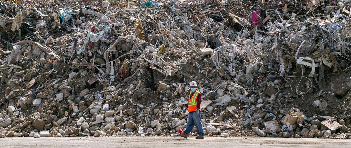 Large piles of debris and rubble from the collapsed Champlain Towers South can be seen inside a lot near the Miami International Airport at the intersection of Milam Dairy Road and Northwest 12th Street in Miami on Saturday, July 10, 2021.
