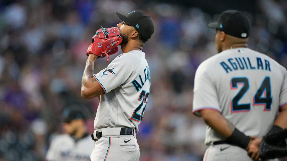Miami Marlins starting pitcher Sandy Alcantara, front left, waits to be pulled from the mound after giving up a three-run home run to Colorado Rockies’ C.J. Cron in the fourth inning of a baseball game Friday, Aug. 6, 2021, in Denver. (AP Photo/David Zalubowski)