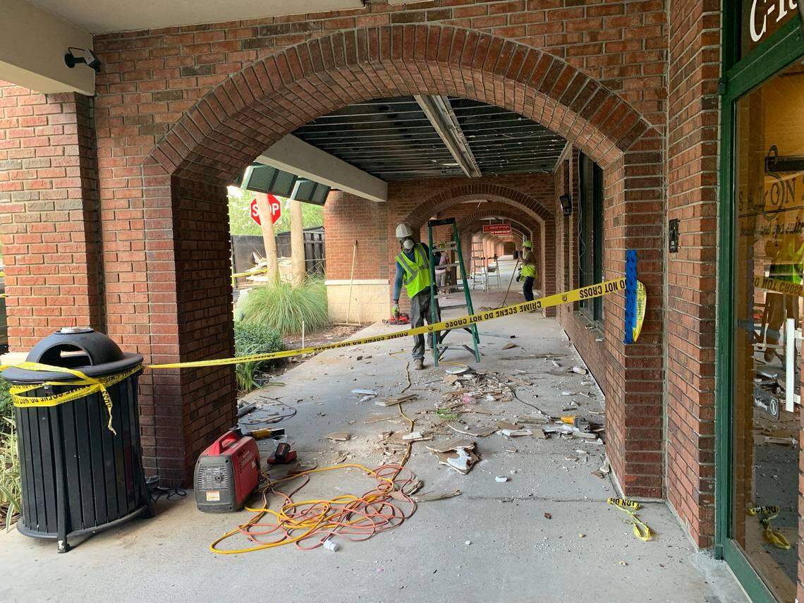Construction workers begin the cleanup process at the Fountains plaza mall in Plantation after a possible gas leak explosion leveled nearby buildings and injured 23 people.