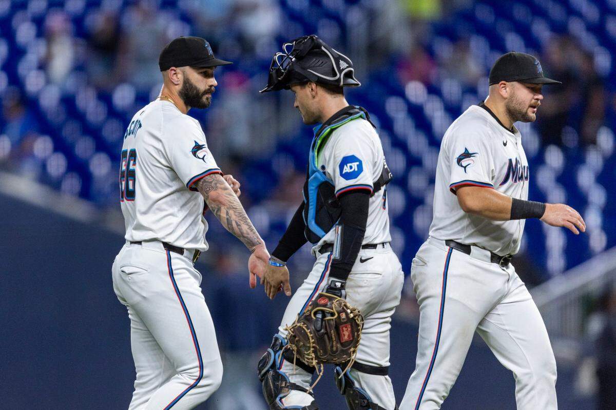 Miami Marlins relief pitcher Tanner Scott (66) interacts with Miami Marlins catcher Nick Fortes (4) after defeating the Milwaukee Brewers 1-0 during an MLB game at LoanDepot Park on Wednesday, May 22, 2024, in Miami, Fla.