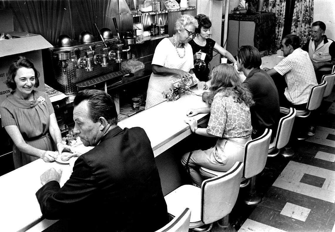 Volunteers at the First Methodist Church storefront serve coffee to customers.