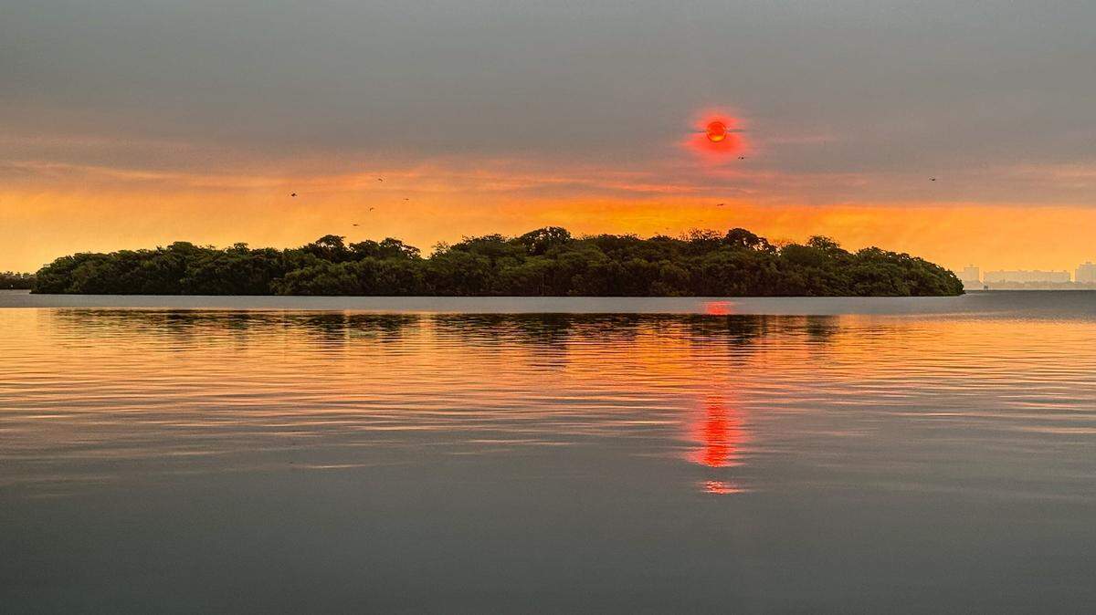 A ruby red sun over Biscayne Bay on Aug. 20, 2025, in Miami, Florida. 