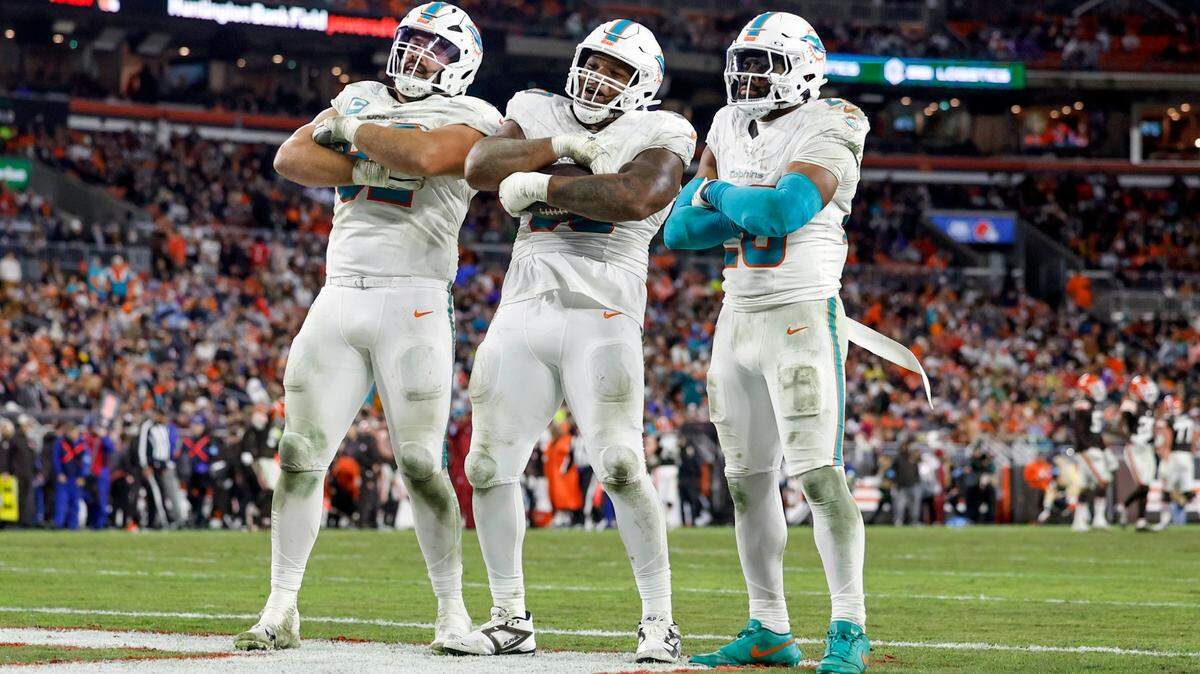 Miami Dolphins defensive tackle Da’Shawn Hand (90) is joined by teammates defensive tackle Zach Sieler (92) and linebacker Jordyn Brooks (20) as he celebrates his fumble recovery by Cleveland Browns quarterback Dorian Thompson-Robinson (17) during the second half of an NFL Football game at Huntington Bank Field in Cleveland, Ohio on Sunday, December 29, 2024.