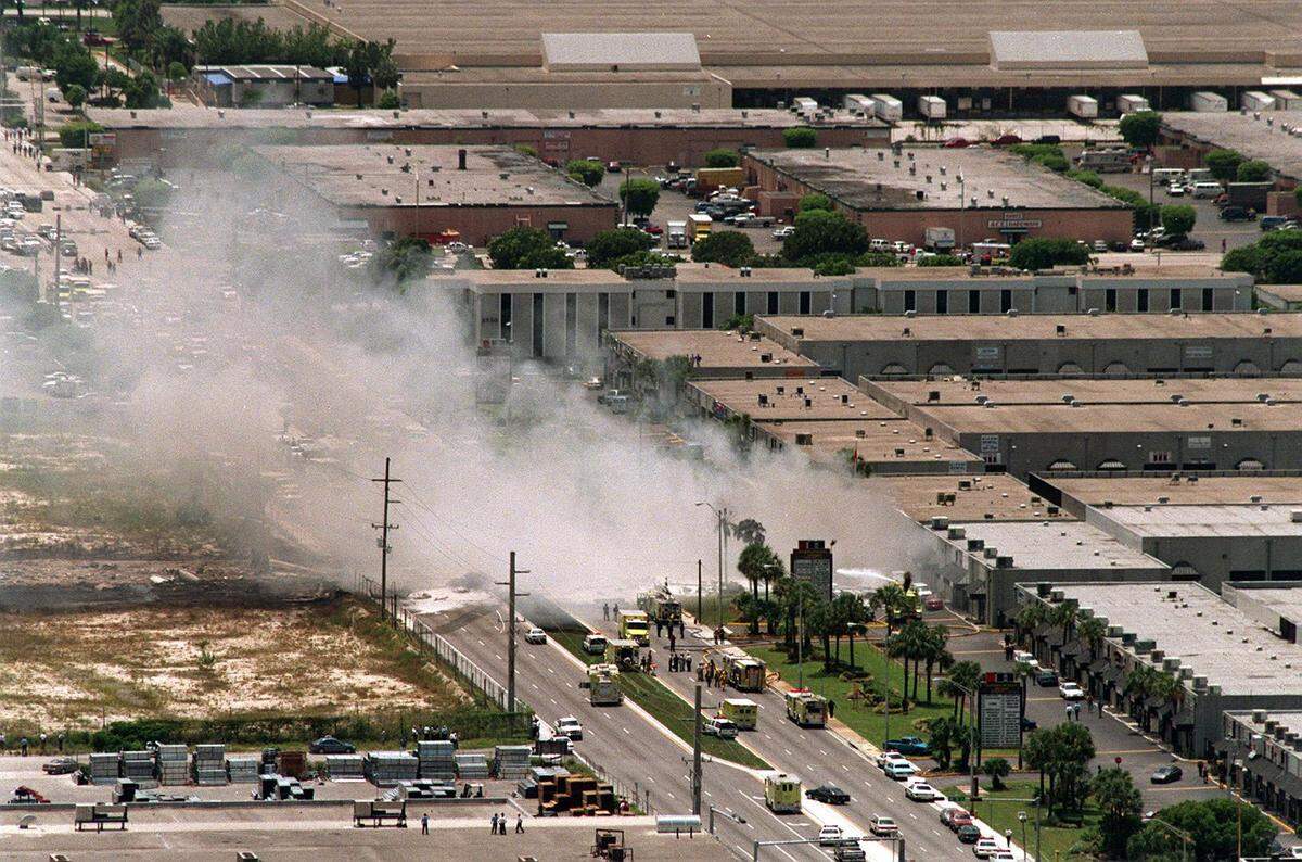 Still-smoking remains of the Fine Air Cargo DC-8 jet came to a rest near offices on N.W. 72nd Ave. The plane crashed shortly after take-off from MIA.