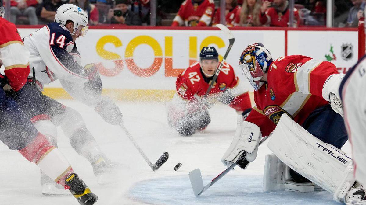 Florida Panthers goaltender Sergei Bobrovsky, right, defends the goal against Columbus Blue Jackets left wing Gustav Nyquist (14) during the first period of an NHL hockey game, Tuesday, Dec. 13, 2022, in Sunrise, Fla. (AP Photo/Lynne Sladky)