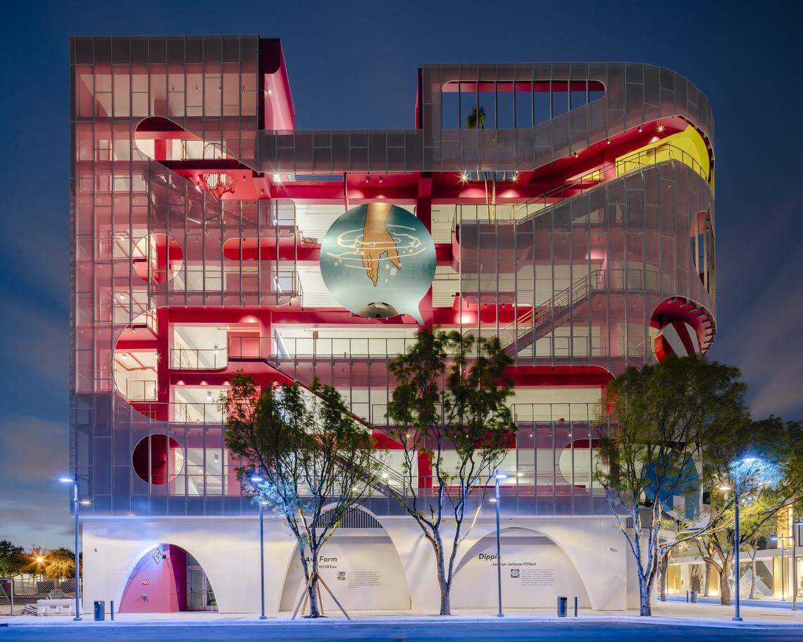 The Museum Garage's "Ant Farm" facade, by architects WORKac. of New York, consists of stairways and public spaces such as a library, a playground, a DJ booth and an art gallery. At the center of the facade is a circular mural, "Dippin," by New York artist Jamien Juliano-Villani, depicting a hand reaching for a bowling ball that's under water.