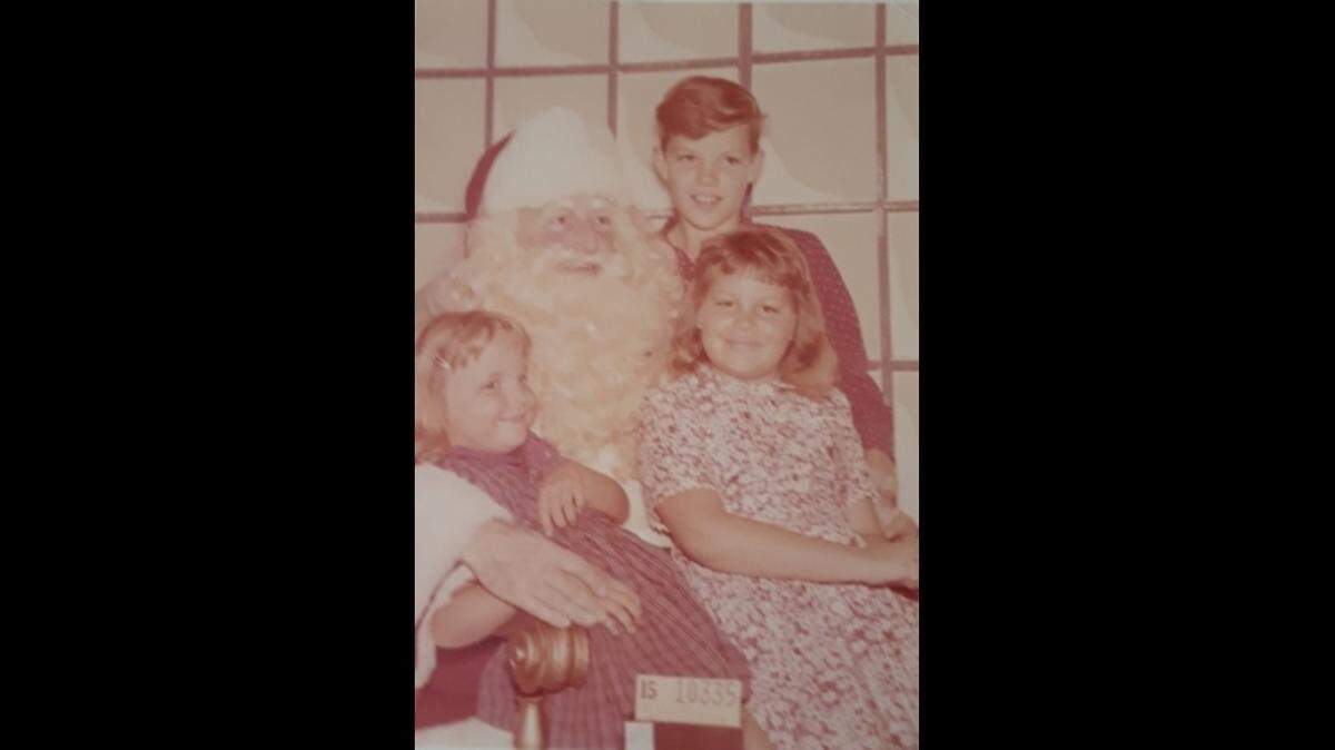 Karin Stahl and her siblings pose with Santa in Burdines department store in downtown Miami in 1960.