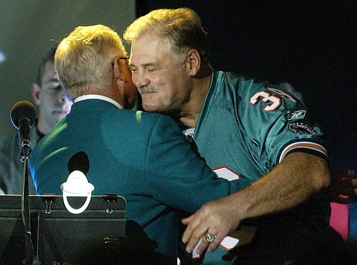 Miami Dolphins former running back Larry Csonka hugs his former coach Don Shula as he is honored at a ceremony to retire his jersey during halftime of the Chicago Bears against the Dolphins on December 9, 2002, at Pro Player Stadium in Miami, Florida.